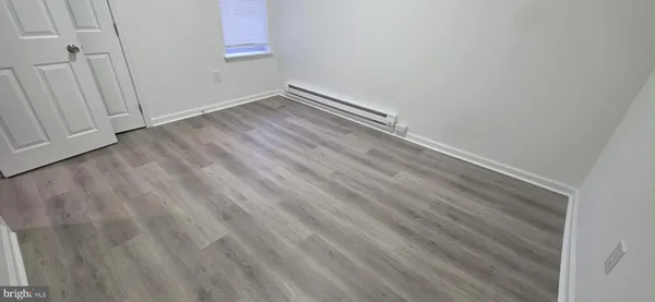 an empty room with wooden floor