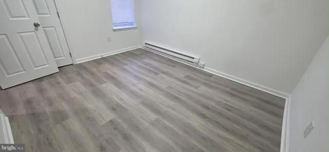 an empty room with wooden floor