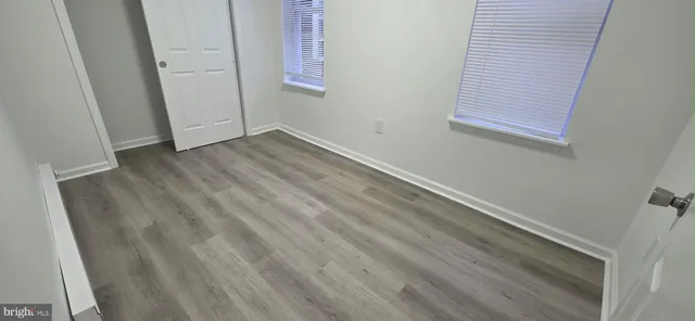 a view of room with wooden floor