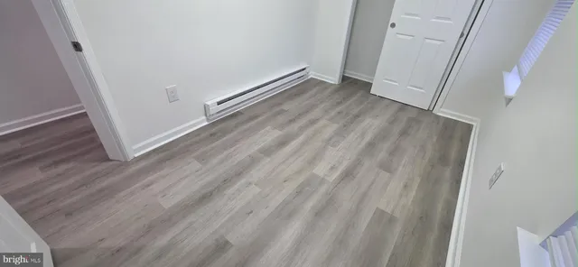 a view of room with wooden floor