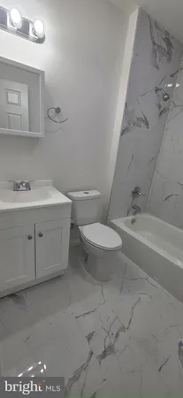 a bath room with a toilet and a bath tub