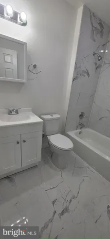 a bath room with a toilet and a bath tub