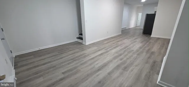 a view of a room with wooden floor