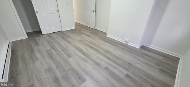 an empty room with wooden floor