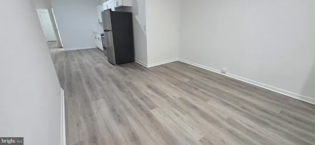 a view of a room with wooden floor