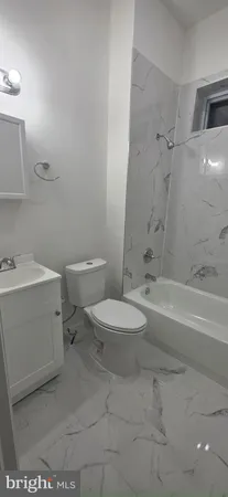 a bathroom with a toilet a sink and bathtub