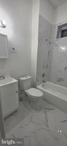 a bathroom with a toilet a sink and bathtub