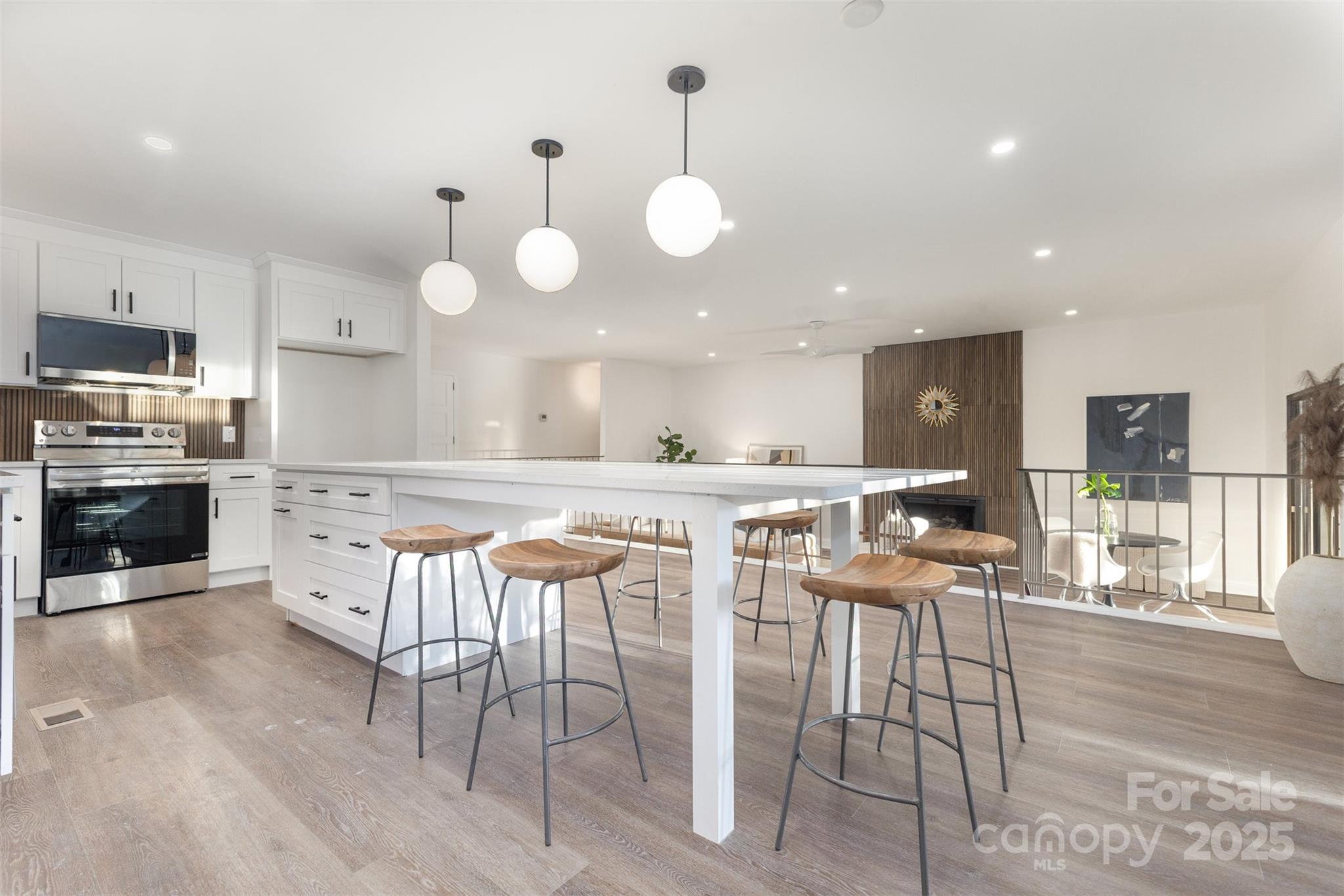 a large kitchen with a table and chairs