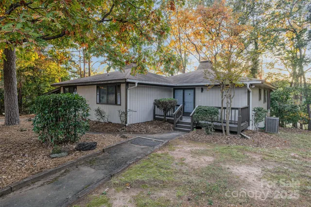 a view of a patio with table and chairs under an umbrella