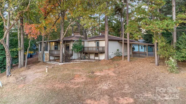 an aerial view of residential houses with outdoor space and lake view