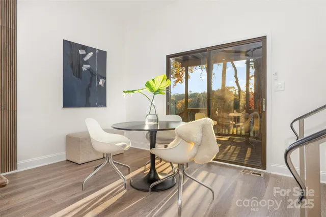 a dining room with furniture and wooden floor