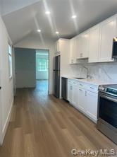 152 South Country Road, Unit B Bellport, NY 11713 - Photo 3 of 8 a kitchen with stainless steel appliances granite countertop a stove a sink and a refrigerator