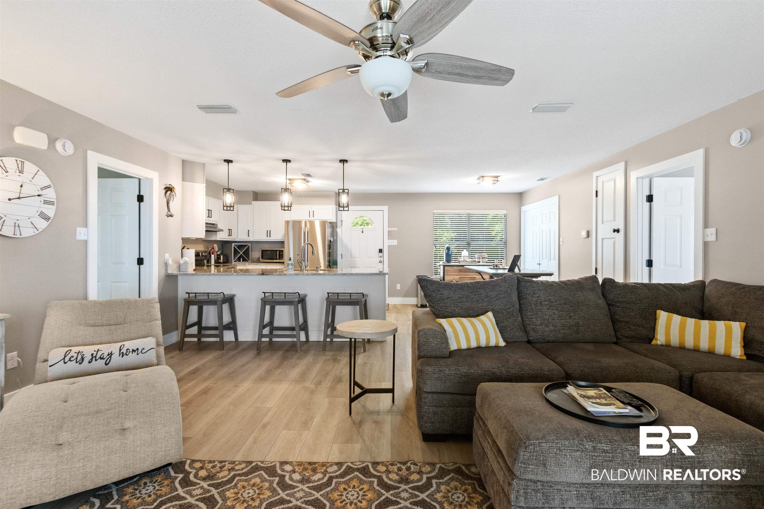 9581 South Bay Street Foley, AL 36535 - Photo 13 of 44 Open-concept living area featuring wood-finish flooring and a ceiling fan with integrated lighting