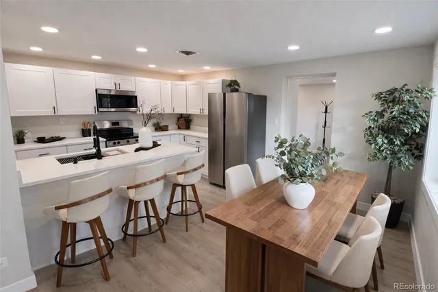 a kitchen with a table and chairs in it