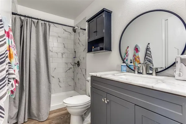 a bathroom with a sink a toilet and a mirror