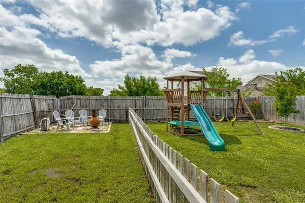 a view of a backyard with swings