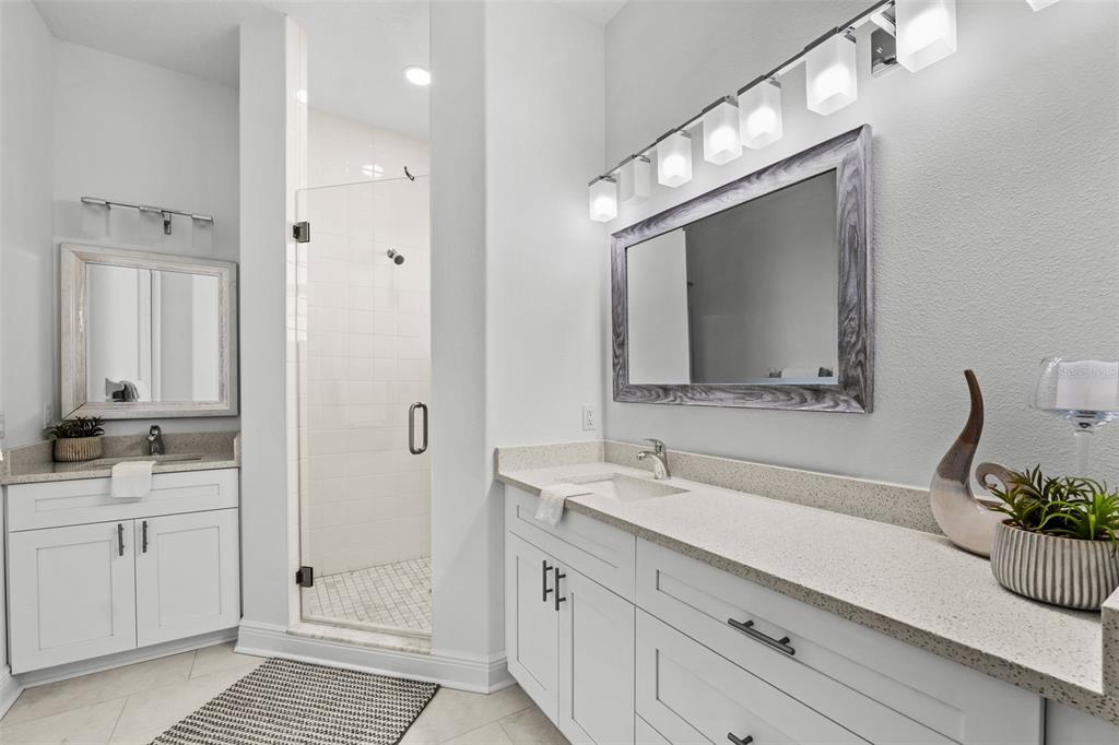 5730 Biscayne Court, Unit 6 New Port Richey, FL 34652 - Photo 16 of 55 a bathroom with a sink a large mirror and a shower