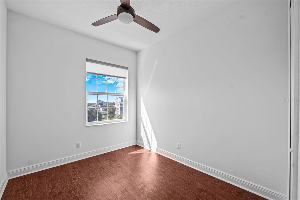 5730 Biscayne Court, Unit 6 New Port Richey, FL 34652 - Photo 19 of 55 an empty room with a window and wooden floor