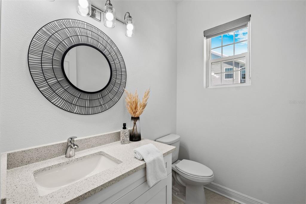 5730 Biscayne Court, Unit 6 New Port Richey, FL 34652 - Photo 22 of 55 a bathroom with a sink a toilet and a mirror
