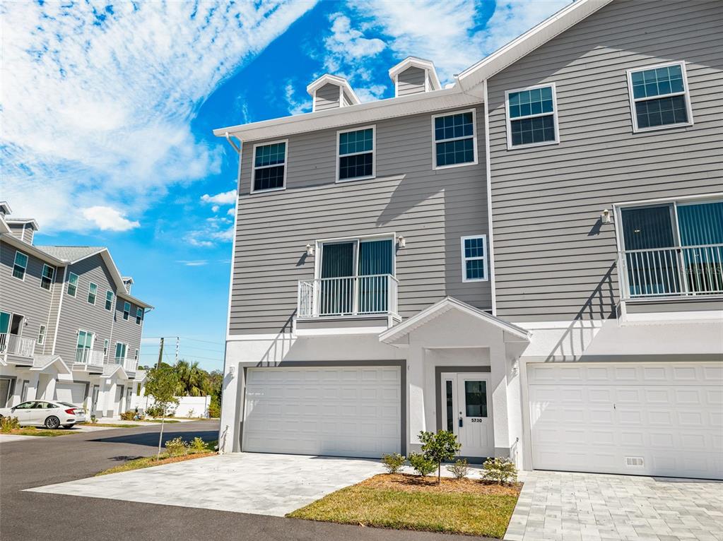 5730 Biscayne Court, Unit 6 New Port Richey, FL 34652 - Photo 27 of 55 a front view of a house with a yard