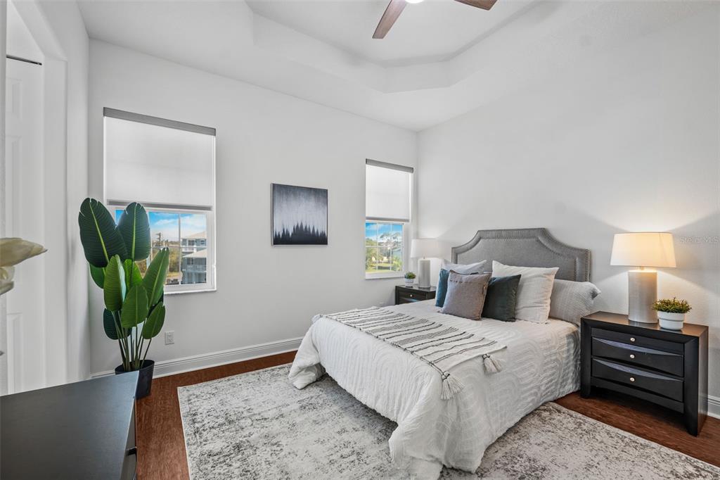 5730 Biscayne Court, Unit 6 New Port Richey, FL 34652 - Photo 10 of 55 a bedroom with a bed a lamp on the dresser and a window