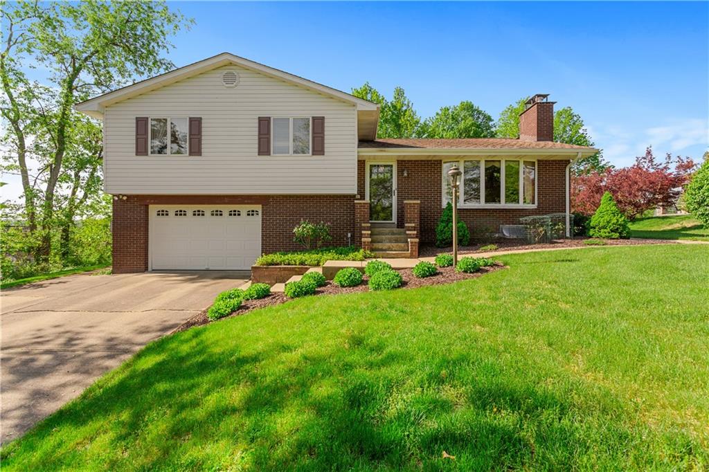 a front view of house with yard and green space