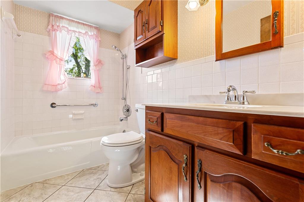 849 Falck Road McKees Rocks, PA 15136 - Photo 15 of 25 a bathroom with a sink a toilet and shower