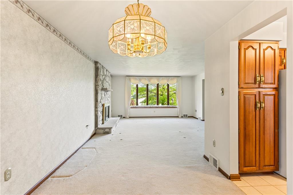 849 Falck Road McKees Rocks, PA 15136 - Photo 5 of 25 an empty room with windows and wooden door