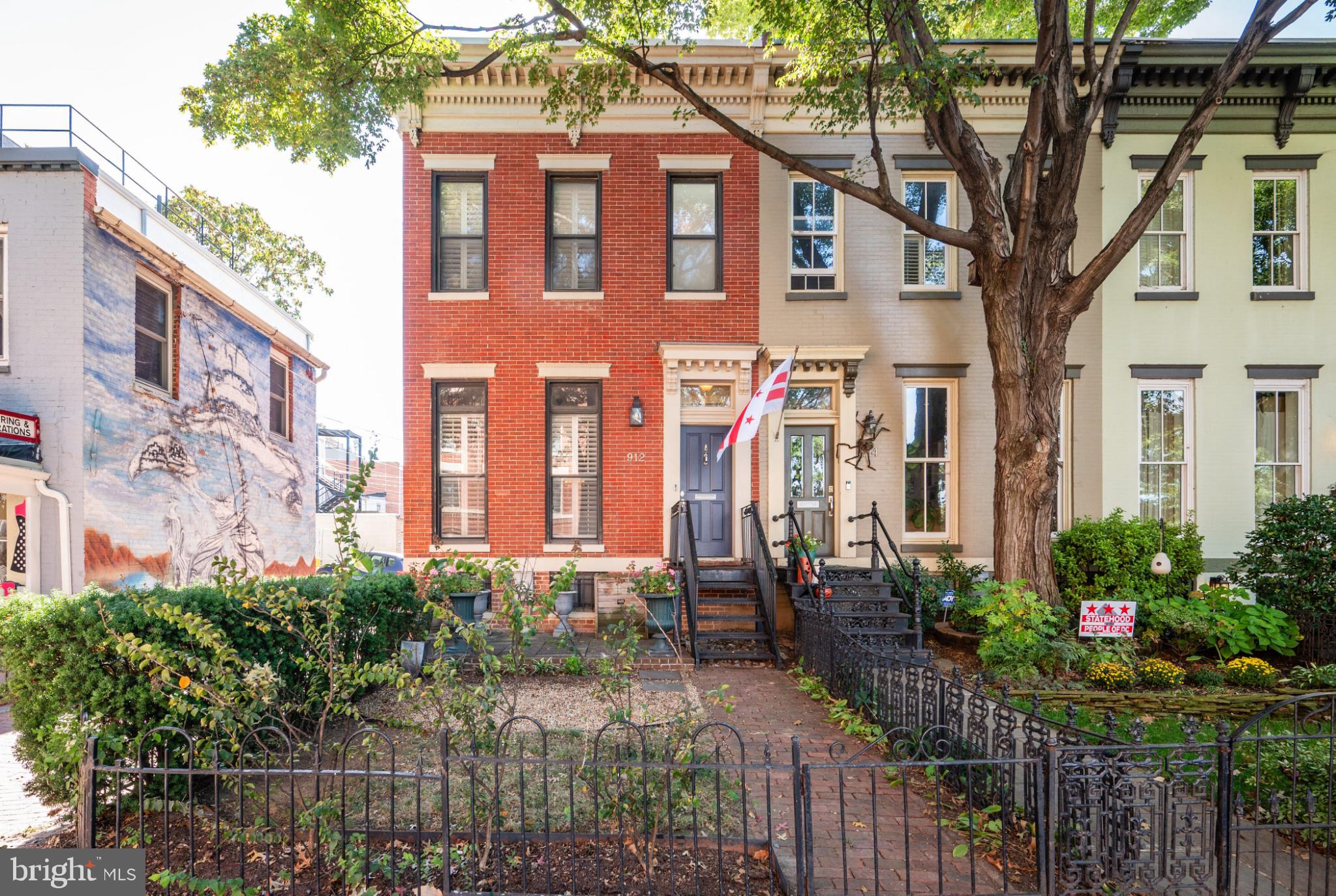 a front view of a house with a garden