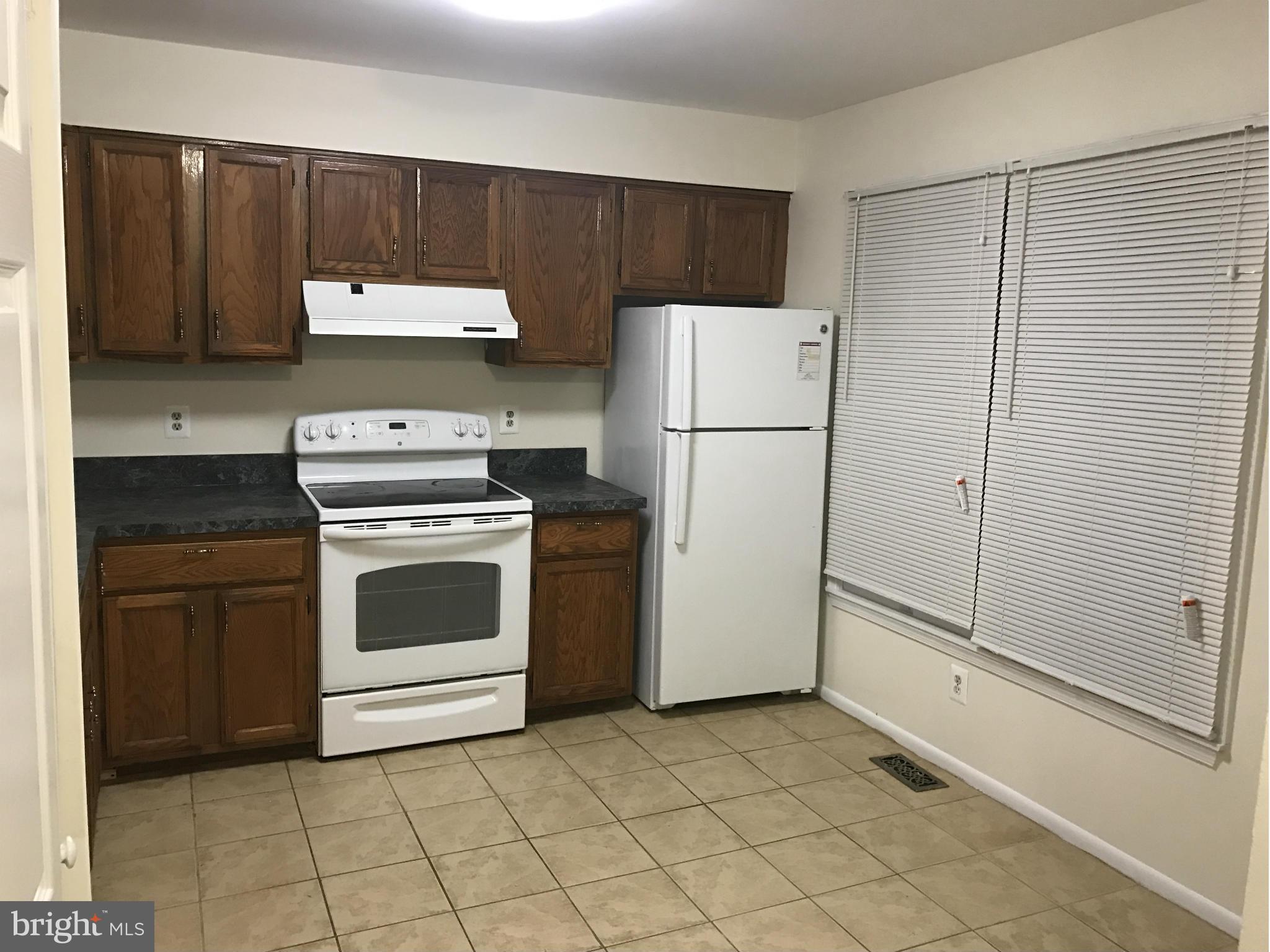 3355 Style Avenue Laurel, MD 20724 - Photo 2 of 15 a kitchen with a stove a refrigerator and a sink
