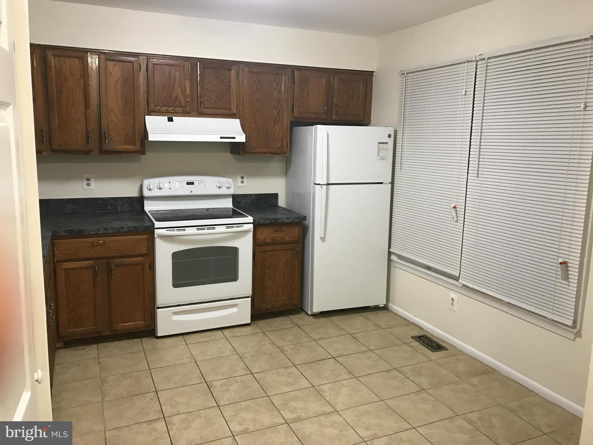 3355 Style Avenue Laurel, MD 20724 - Photo 3 of 15 a kitchen with a stove and a refrigerator