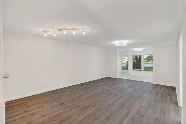 a view of house in front of a big yard with large windows