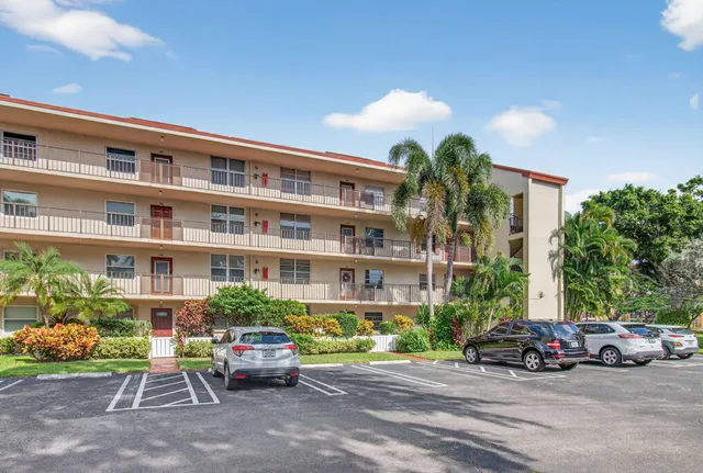 a view of a cars park in front of a building