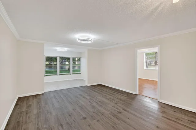 a view of a swimming pool with a patio and a yard