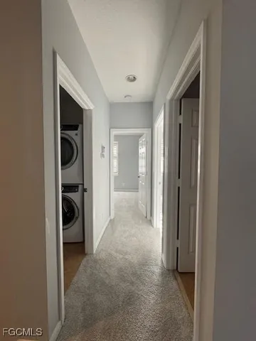 a view of a hallway to closet and a living room