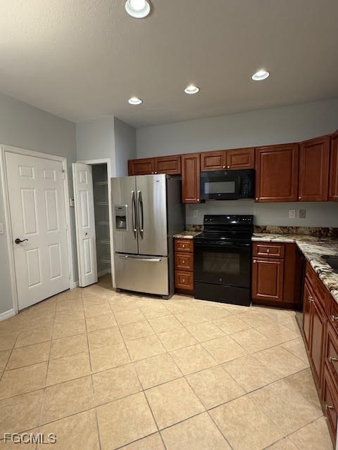 4040 Cherrybrook Loop Fort Myers, FL 33966 - Photo 2 of 18 a kitchen with stainless steel appliances granite countertop a stove a refrigerator and a sink