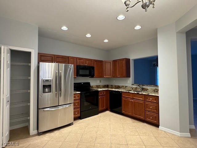4040 Cherrybrook Loop Fort Myers, FL 33966 - Photo 3 of 18 a kitchen with stainless steel appliances granite countertop a stove top oven a refrigerator and a sink