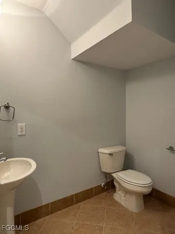 a white toilet sitting next to a bathroom sink