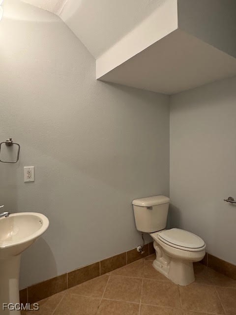 4040 Cherrybrook Loop Fort Myers, FL 33966 - Photo 5 of 18 a white toilet sitting next to a bathroom sink