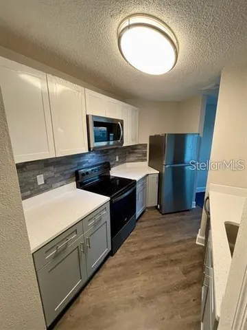 a kitchen with appliances cabinets and a sink
