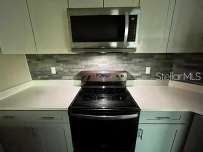 a kitchen with a stove and a microwave