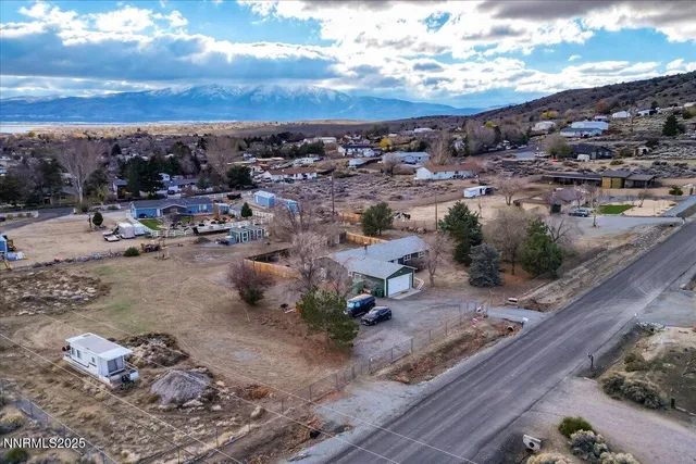 a view of a house with a tree and garage