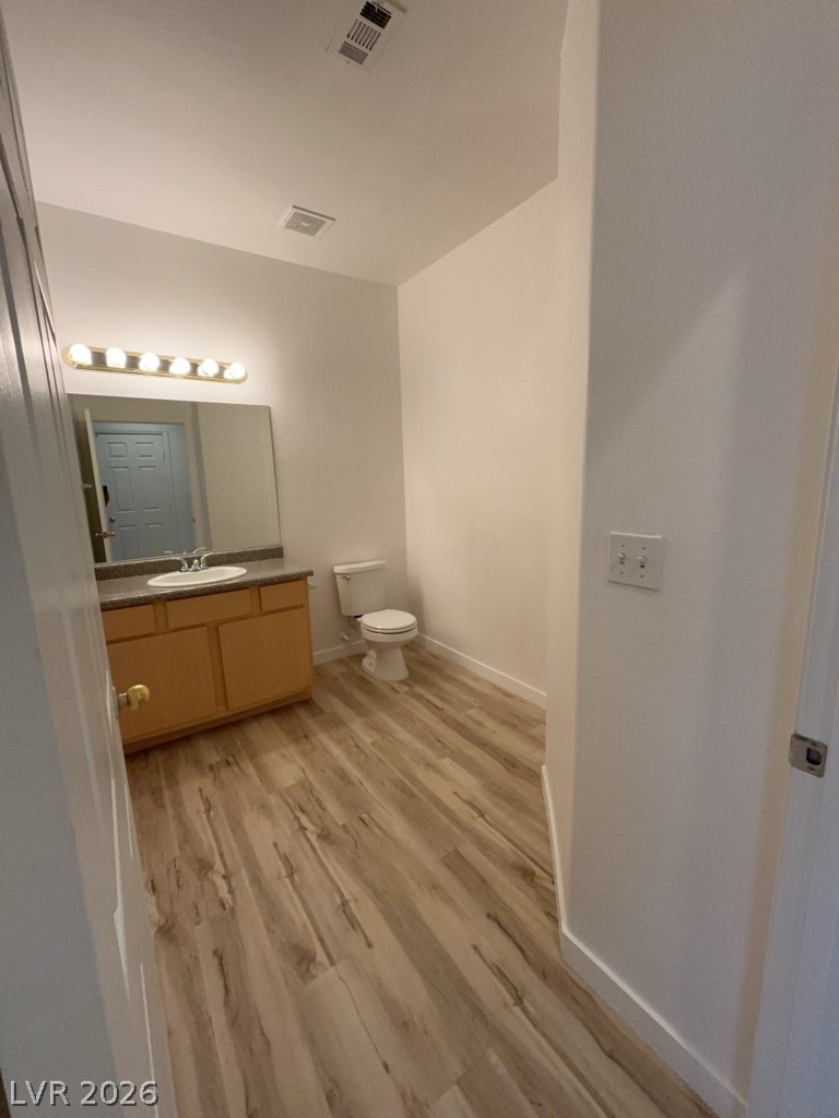 4915 East Russell Road, Unit 143 Las Vegas, NV 89120 - Photo 5 of 10 A pristine bathroom featuring modern wood-look flooring and a functional vanity.