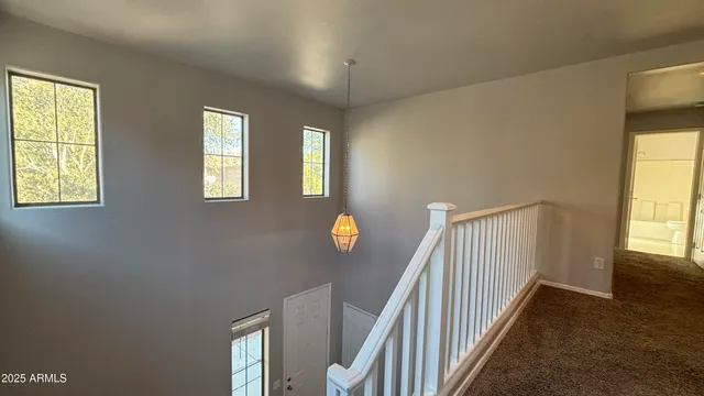 a view of staircase with wooden floor and windows
