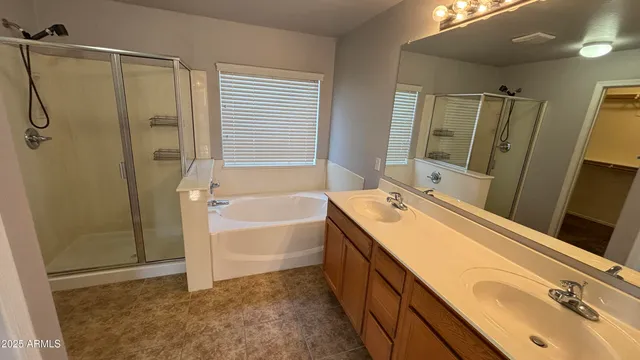 a bathroom with a tub sink and mirror