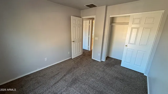 an empty room with closet area