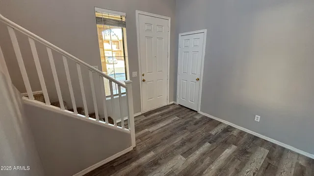 a view of a hallway with wooden floor and entryway