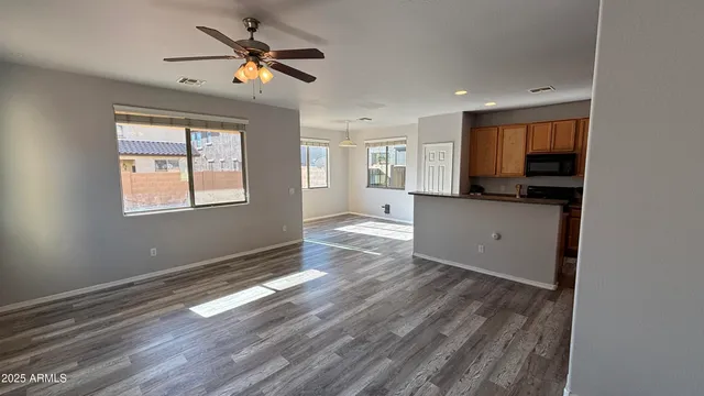 a view of workspace with wooden floor and windows