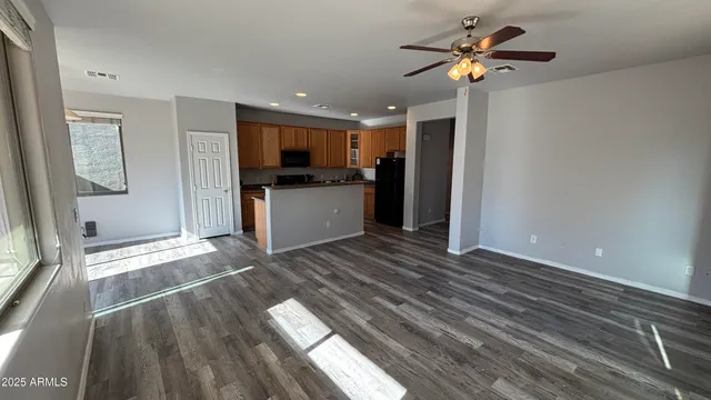 a view of kitchen with sink microwave and refrigerator