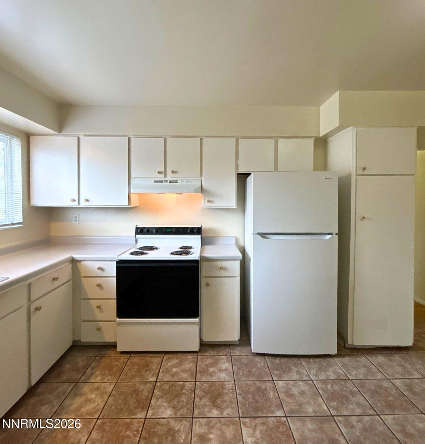 3285 Gypsum Road Reno, NV 89503 - Photo 3 of 17 a kitchen with a refrigerator sink stove and cabinets